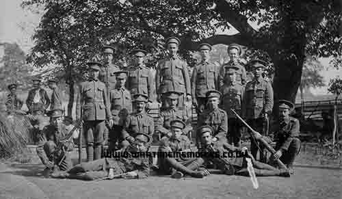 <p>Private Harry Thurlow.  Photograph taken at Sittingbourne.  Harry crouched on one knee, front row, far left.